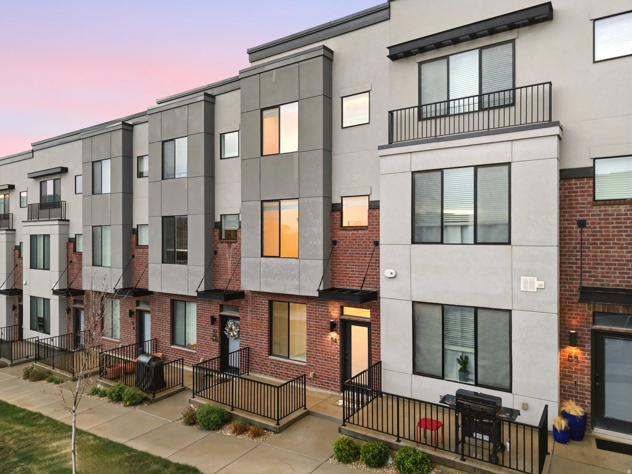 Contemporary home featuring stucco siding and brick siding