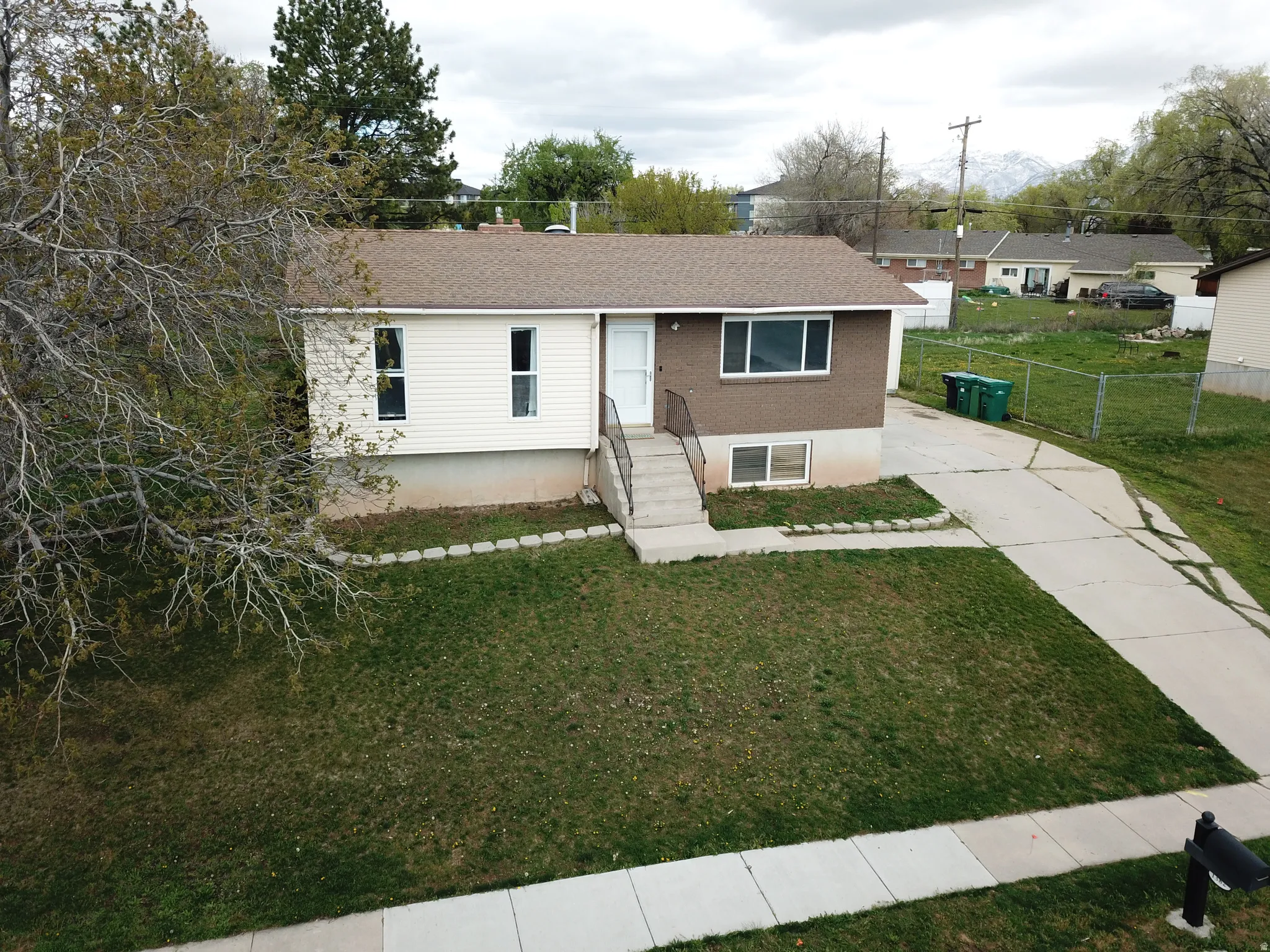 Ranch-style house featuring roof with shingles