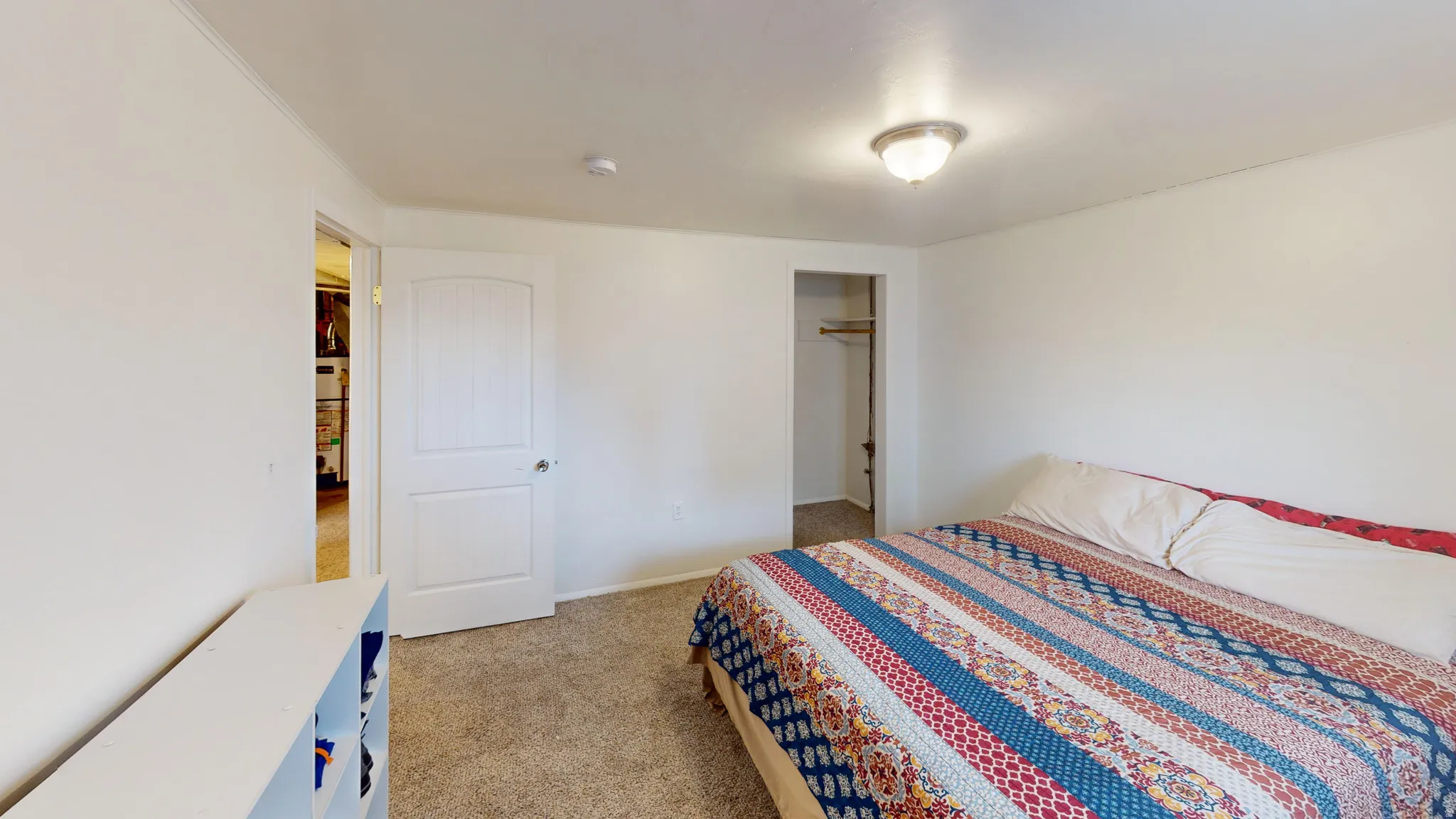 Bedroom featuring light colored carpet and a closet
