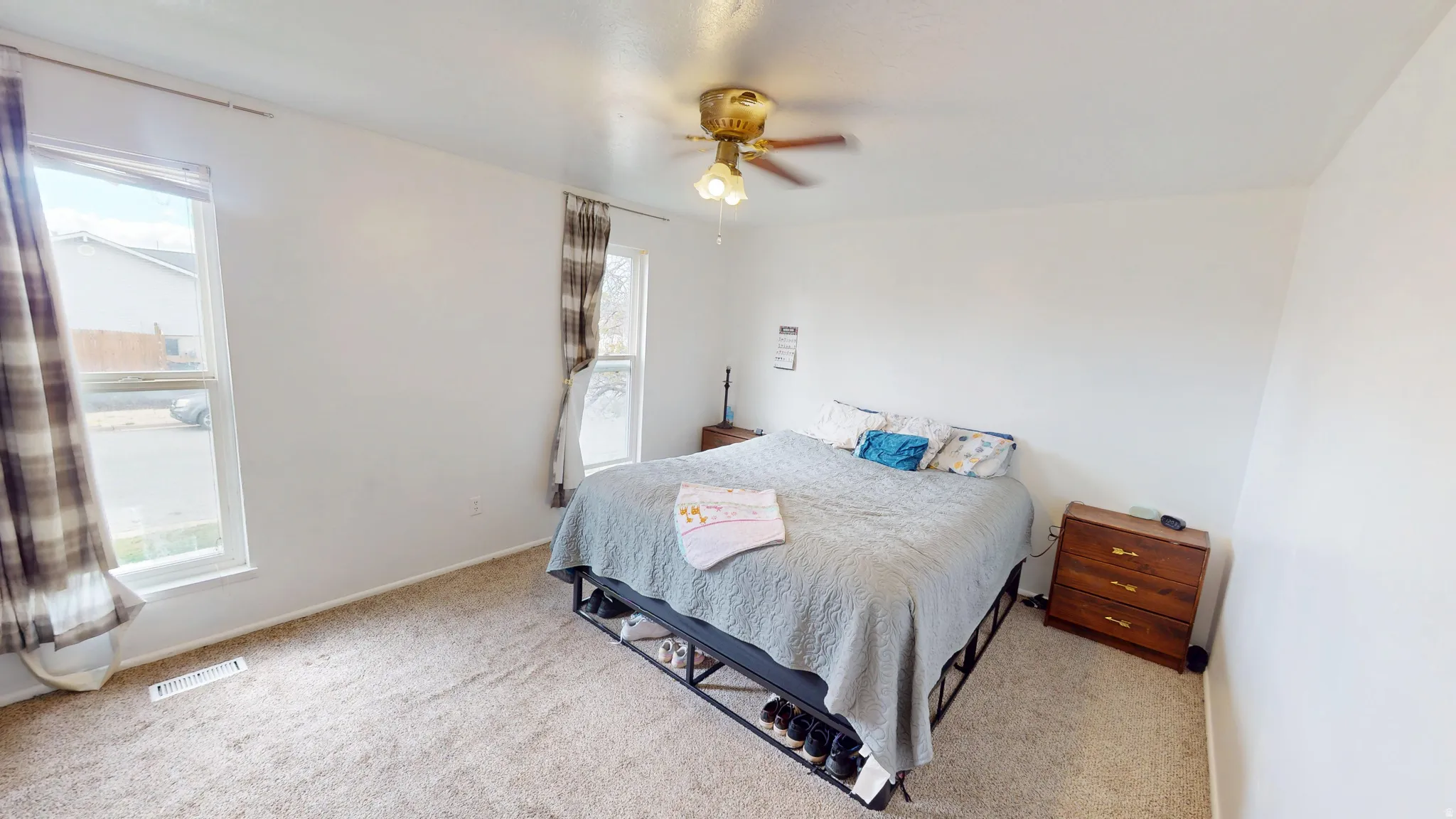 Bedroom with ceiling fan and carpet flooring