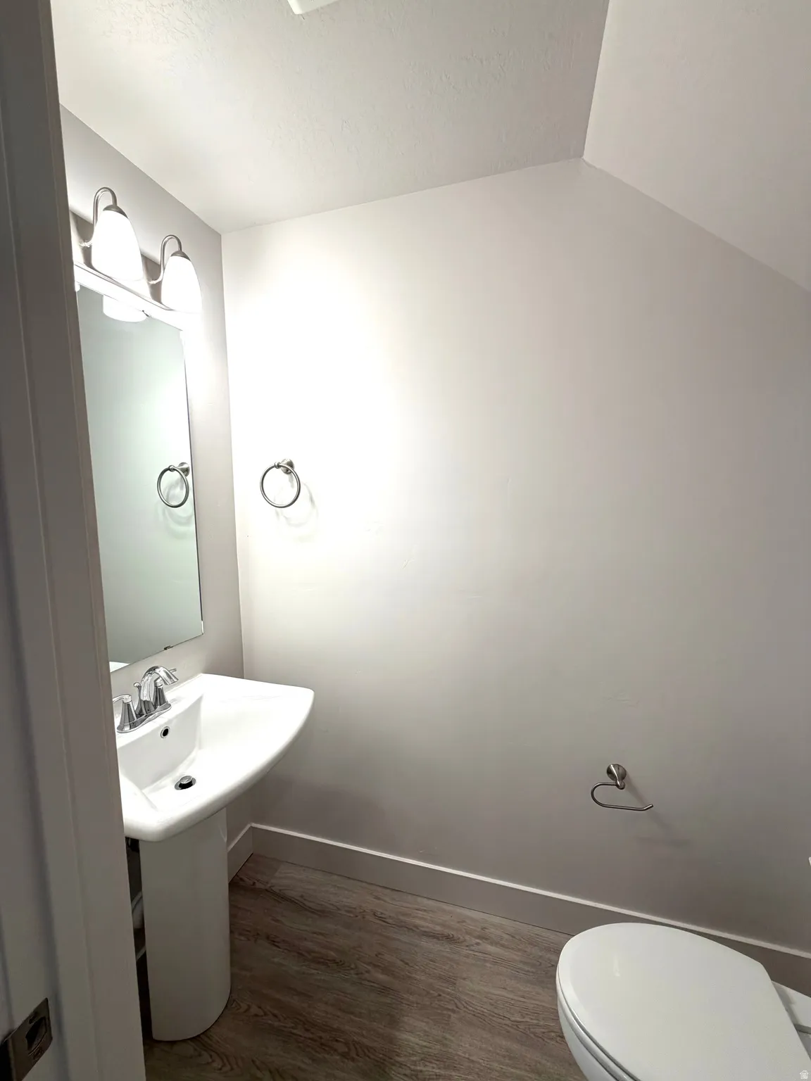 Bathroom with dark wood finished floors and a textured ceiling