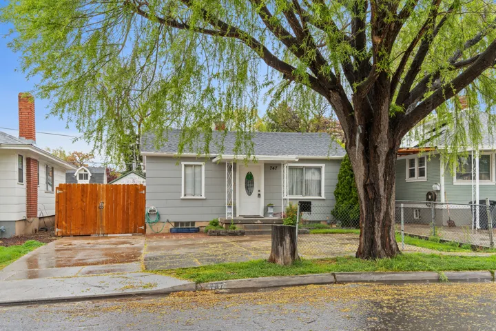 Bungalow-style house with a gate and a shingled roof