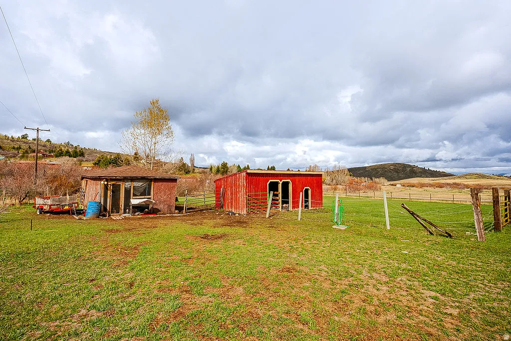 View of yard with an outbuilding and a pole building
