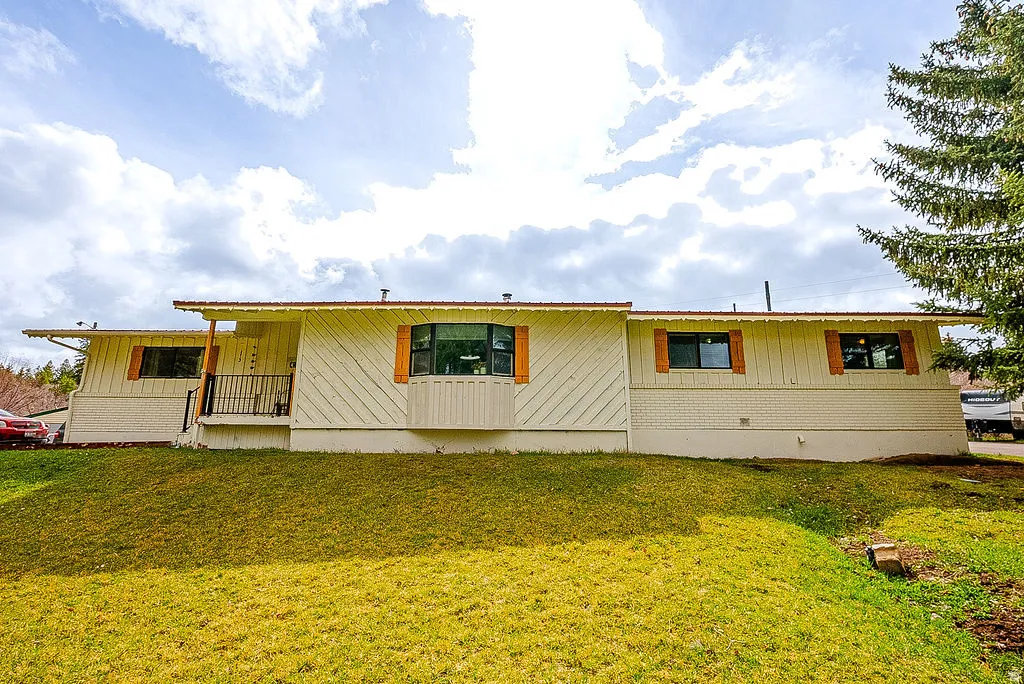 View of front of property featuring a front yard and board and batten siding