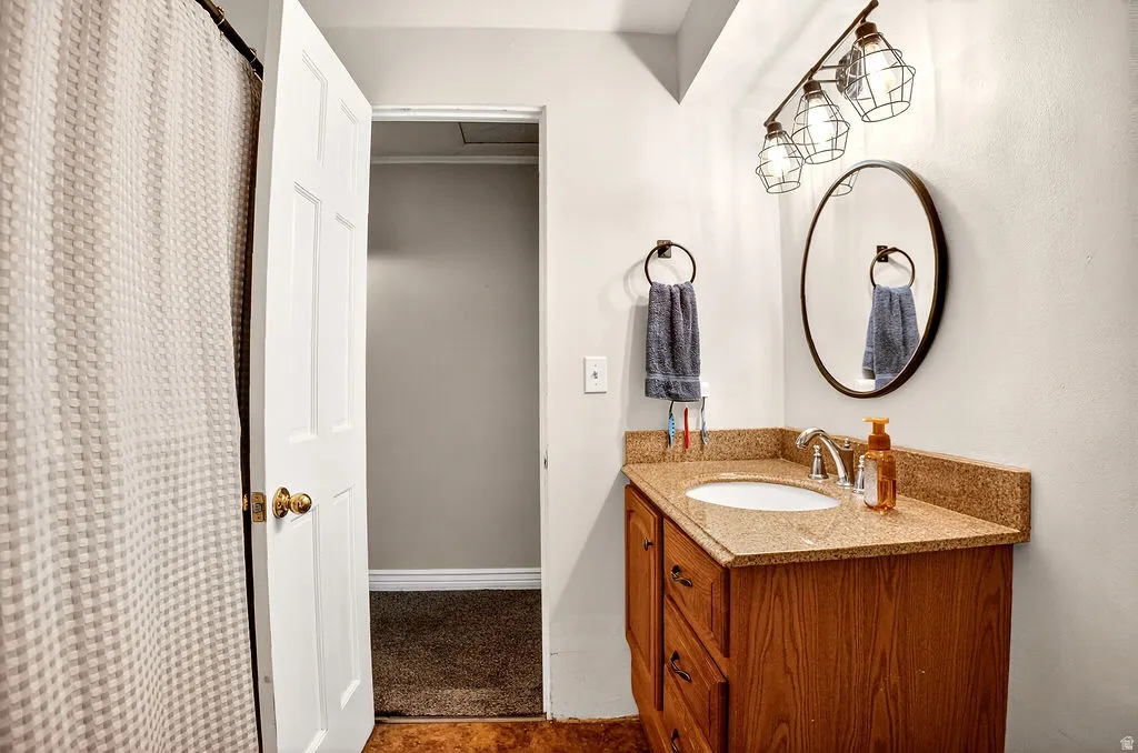 Full bathroom with vanity and curtained shower