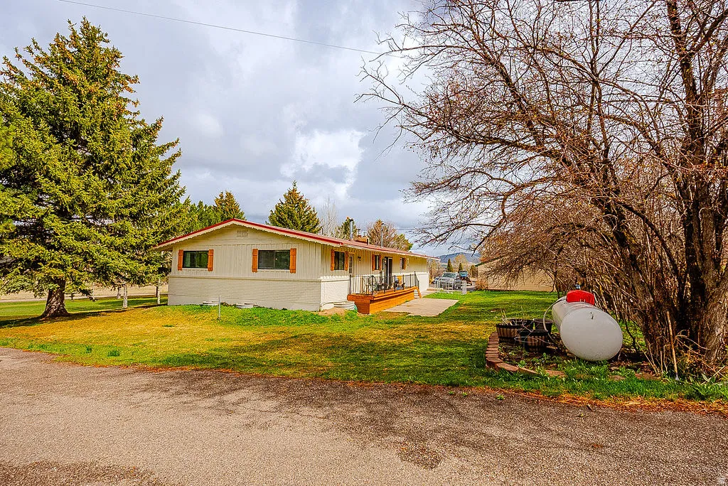 View of side of home with a yard