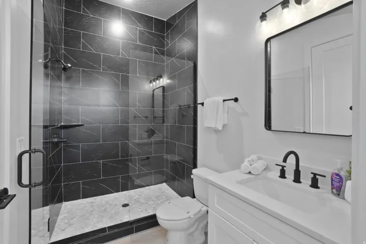 Bathroom featuring a shower stall and vanity