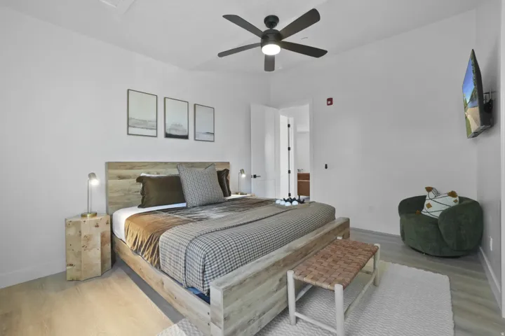 Bedroom featuring wood finished floors and a ceiling fan