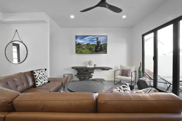 Living area with a ceiling fan and recessed lighting