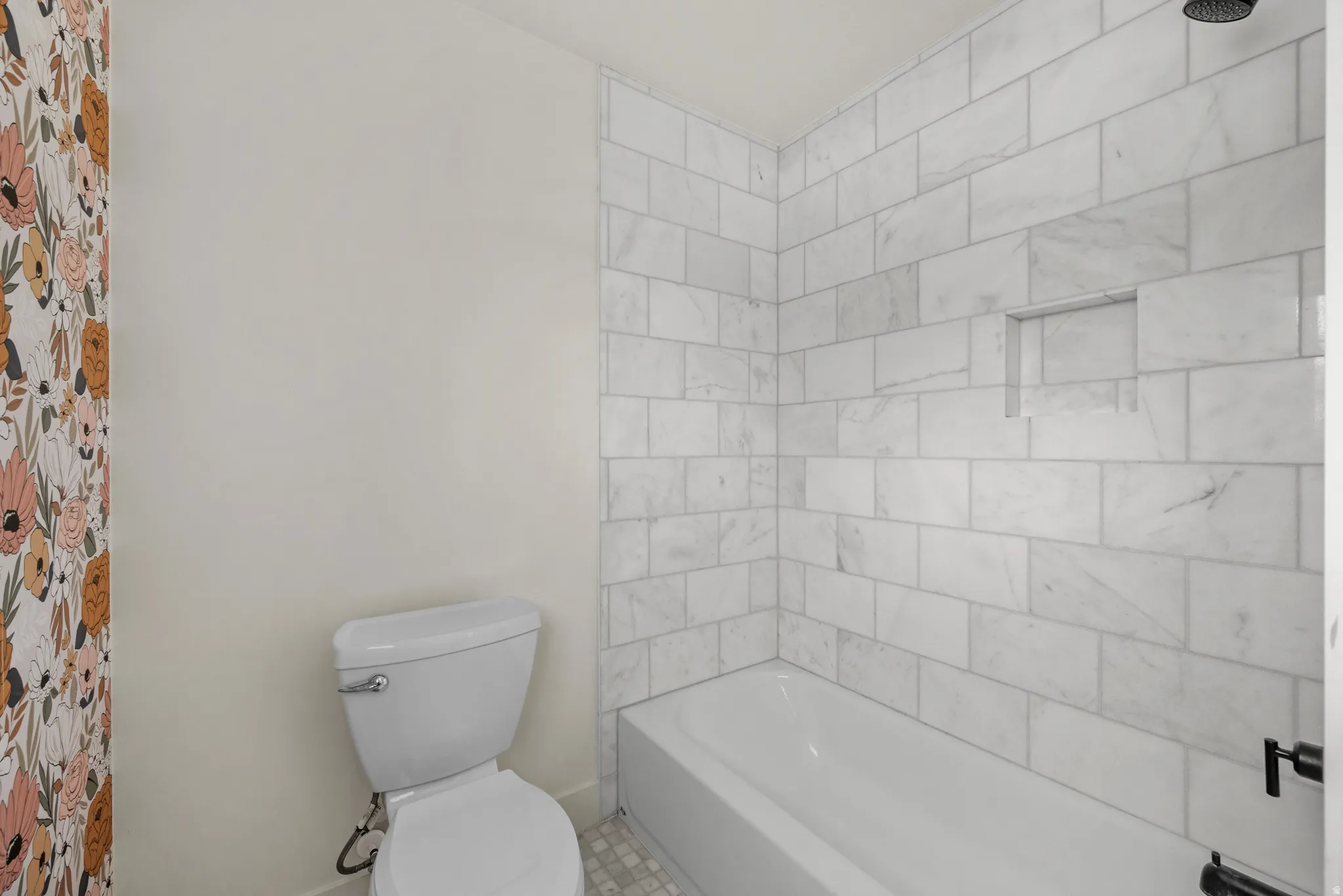 Bathroom featuring toilet and shower / washtub combination