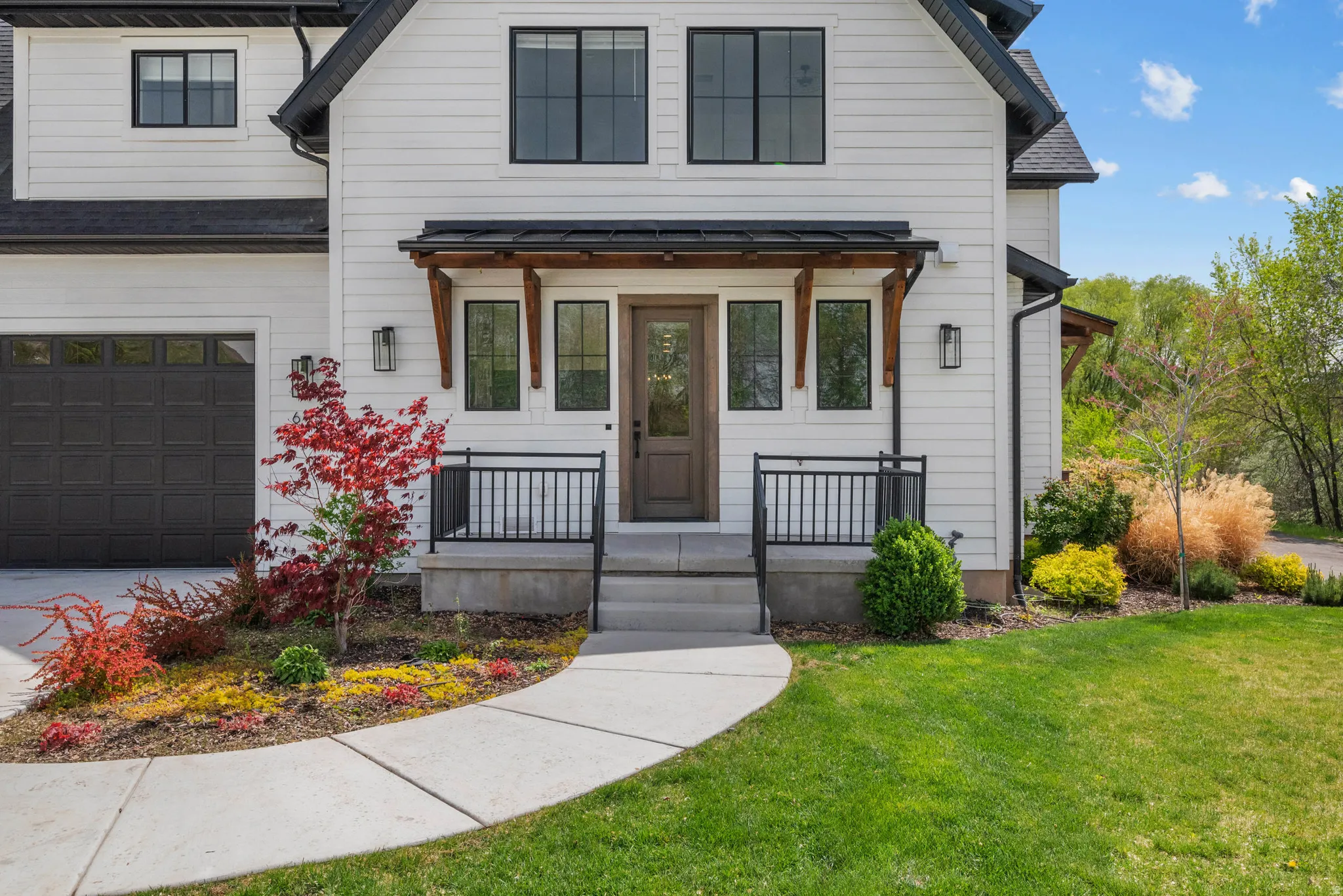 View of front of home with a front lawn, an attached garage, and concrete driveway