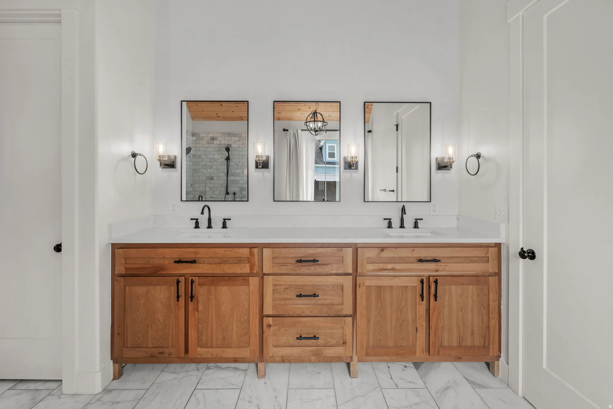 Full bath featuring double vanity and a stall shower