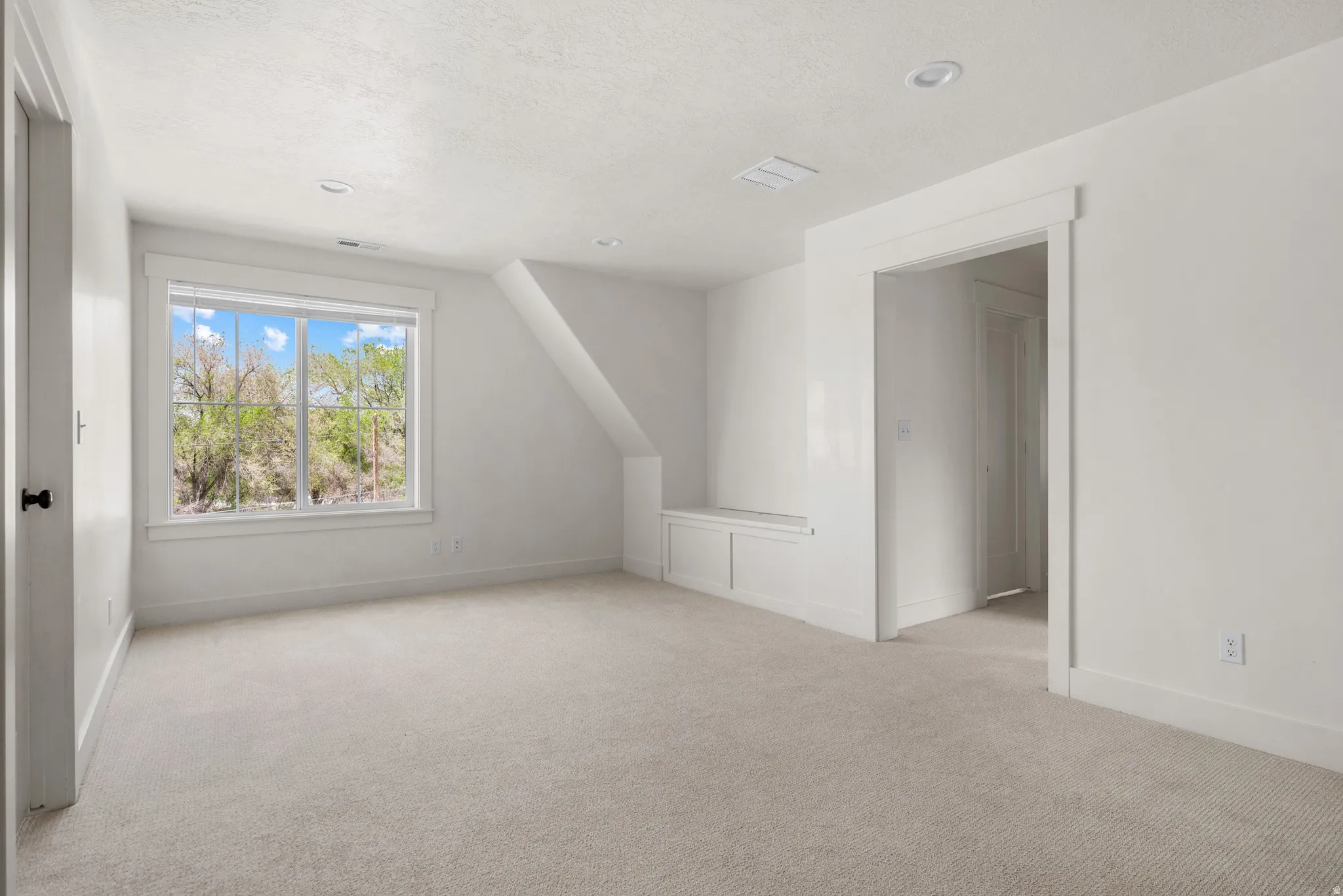 Bonus room featuring light colored carpet, vaulted ceiling, and recessed lighting