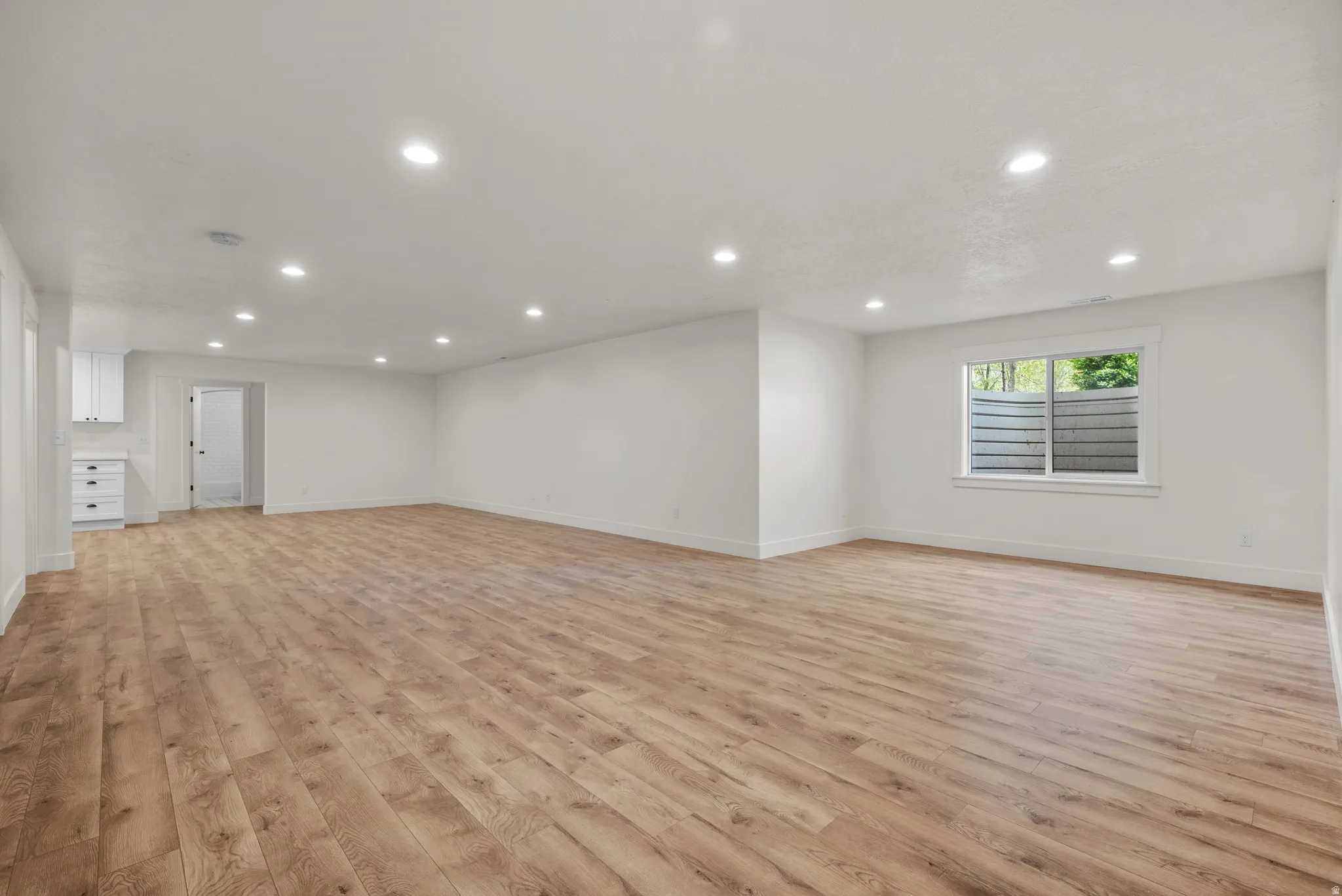 Unfurnished living room featuring light wood-style floors and recessed lighting