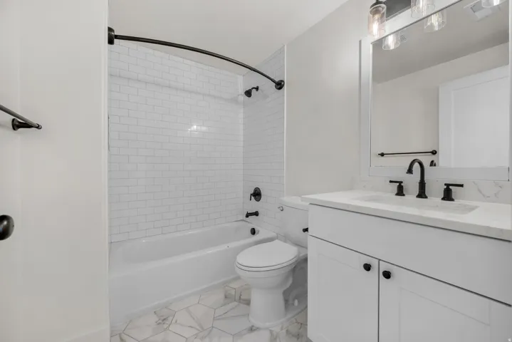 Full bath with vanity and shower / bath combination