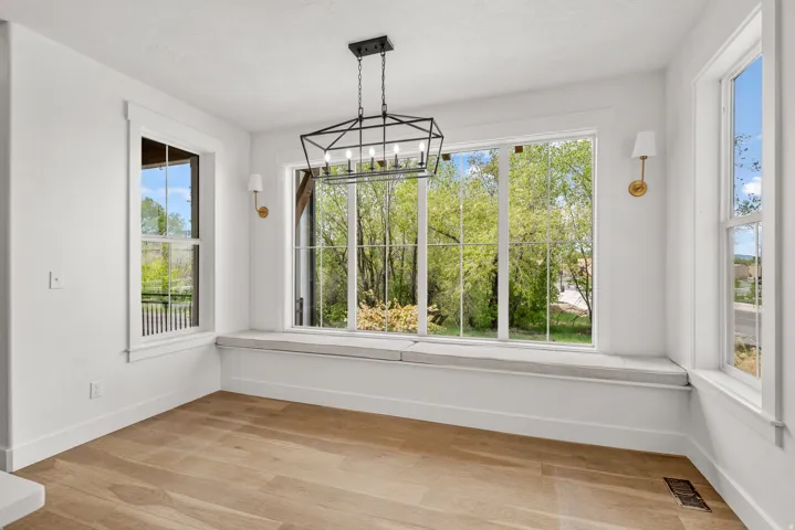 Unfurnished dining area featuring a chandelier and light wood-style floors