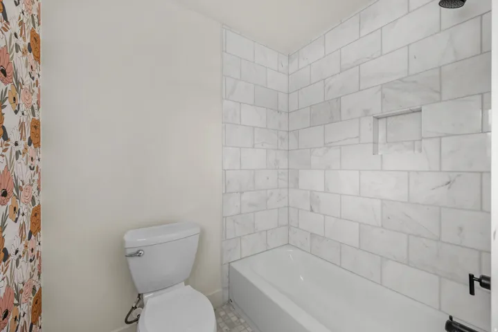 Bathroom featuring toilet and shower / washtub combination