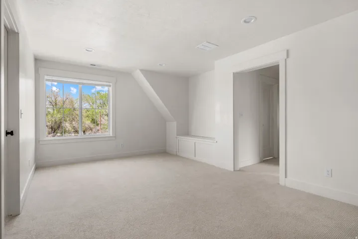 Bonus room featuring light colored carpet, vaulted ceiling, and recessed lighting