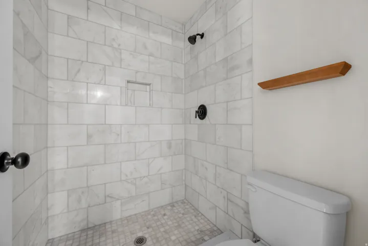 Bathroom with toilet and a stall shower