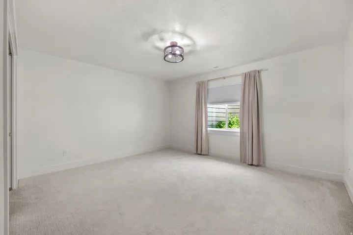 Spare room with a textured ceiling and light carpet