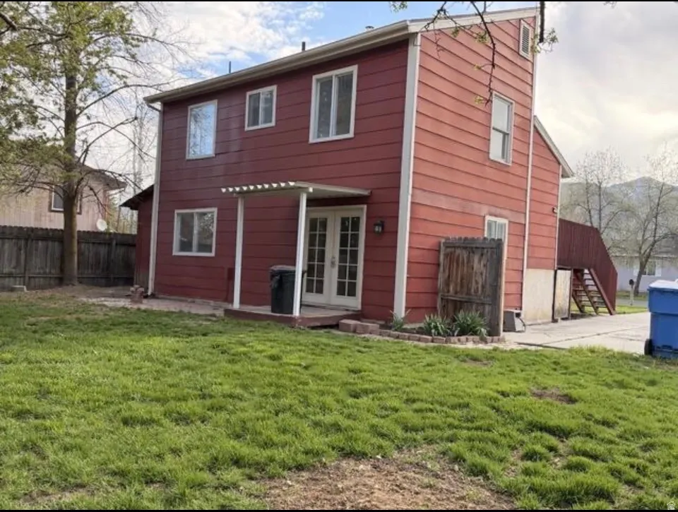Back of property featuring french doors and stairs
