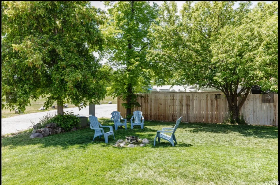 Fenced yard featuring a fire pit