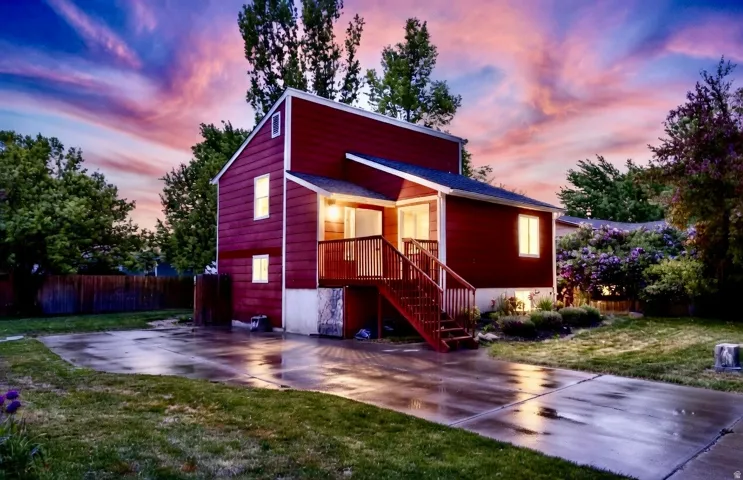 View of front of property featuring a patio area and stairs