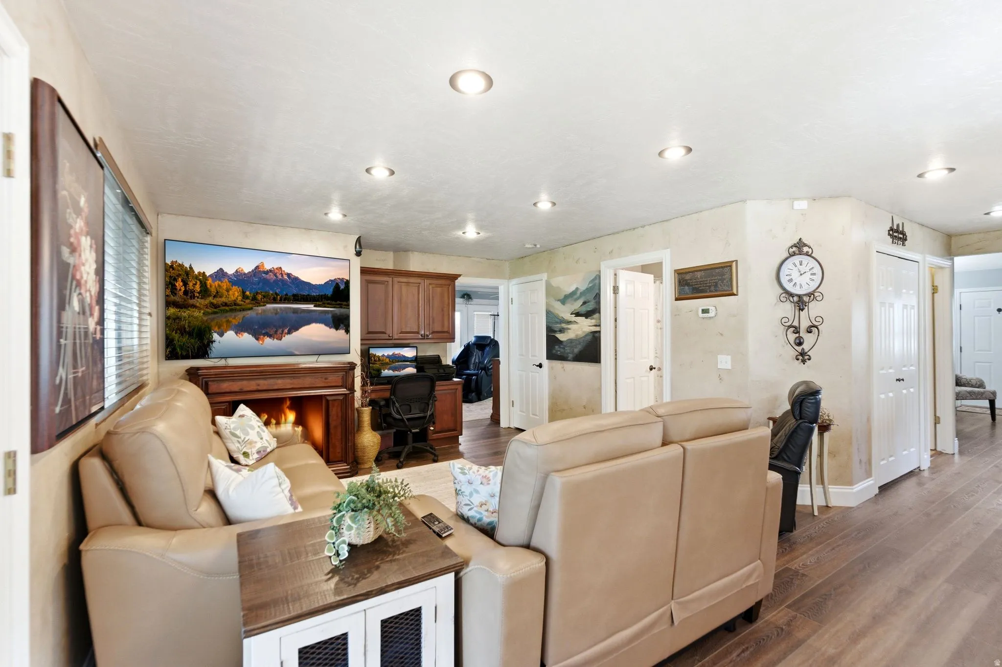 Living room featuring dark wood-style floors, an office area, and recessed lighting