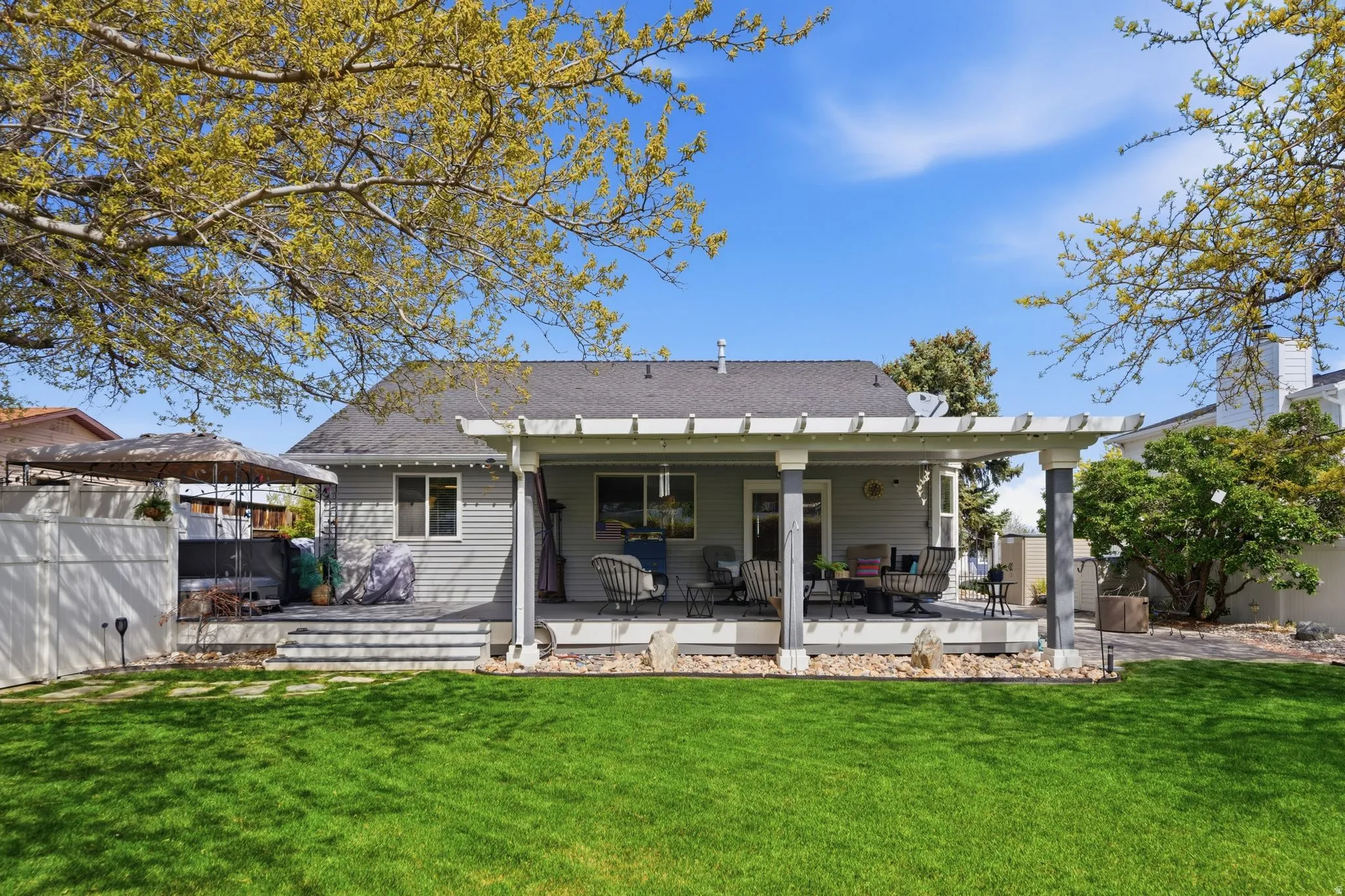 Back of house with roof with shingles and a deck