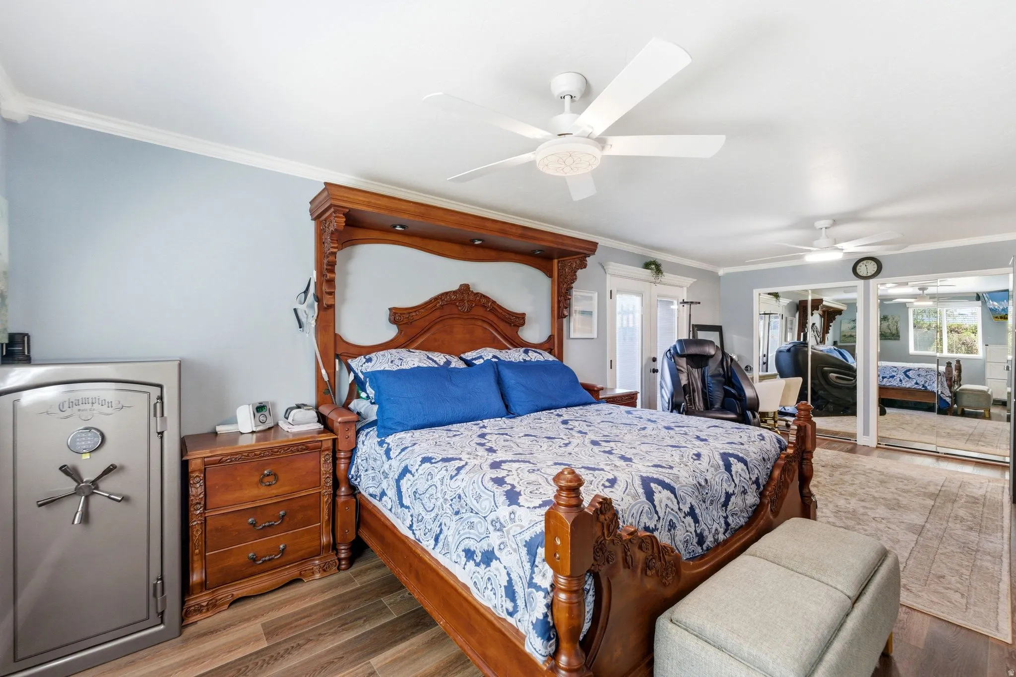 Bedroom with ornamental molding, wood finished floors, a closet, and ceiling fan