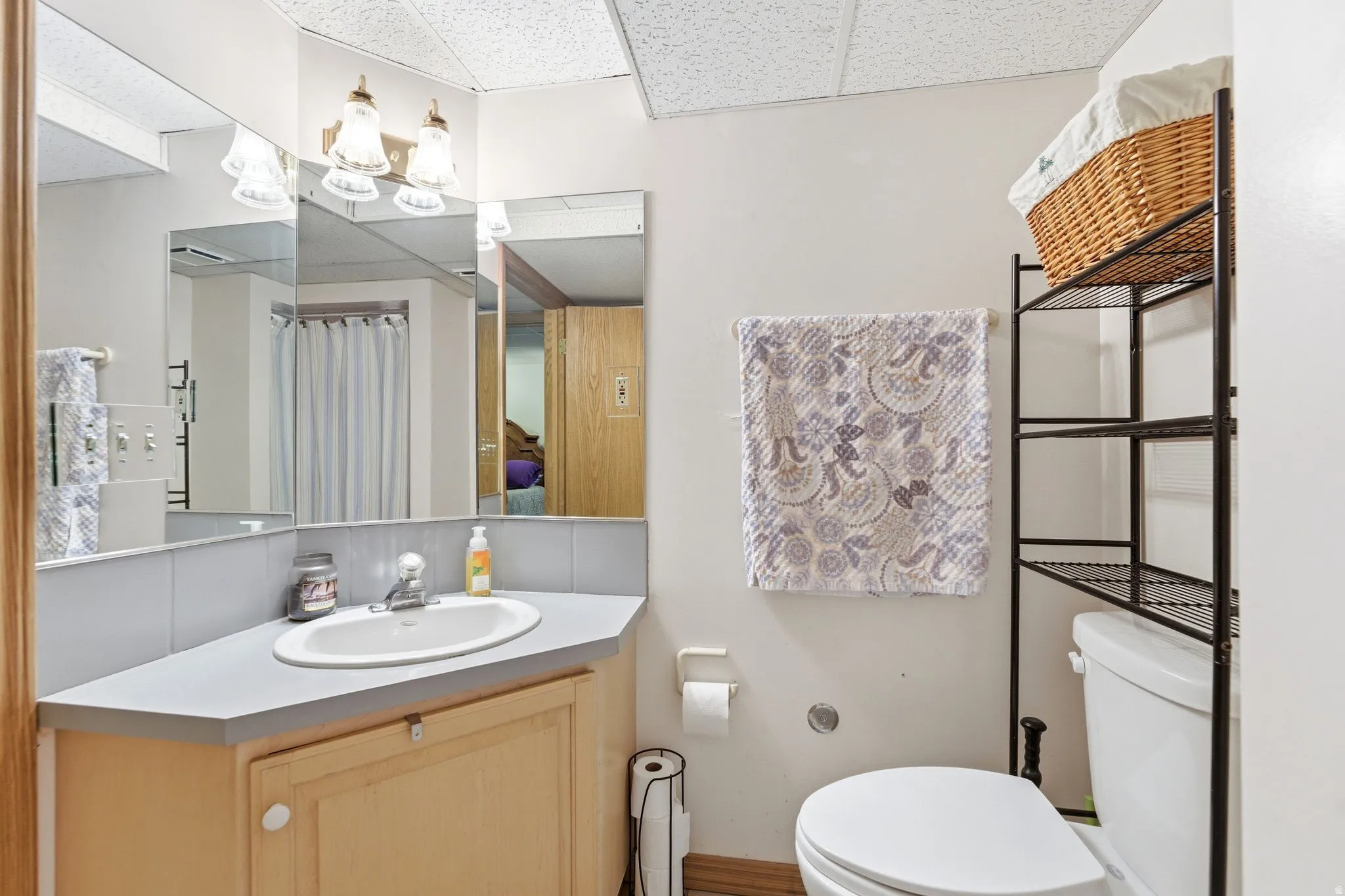Full bath featuring a paneled ceiling, vanity, and a shower with curtain