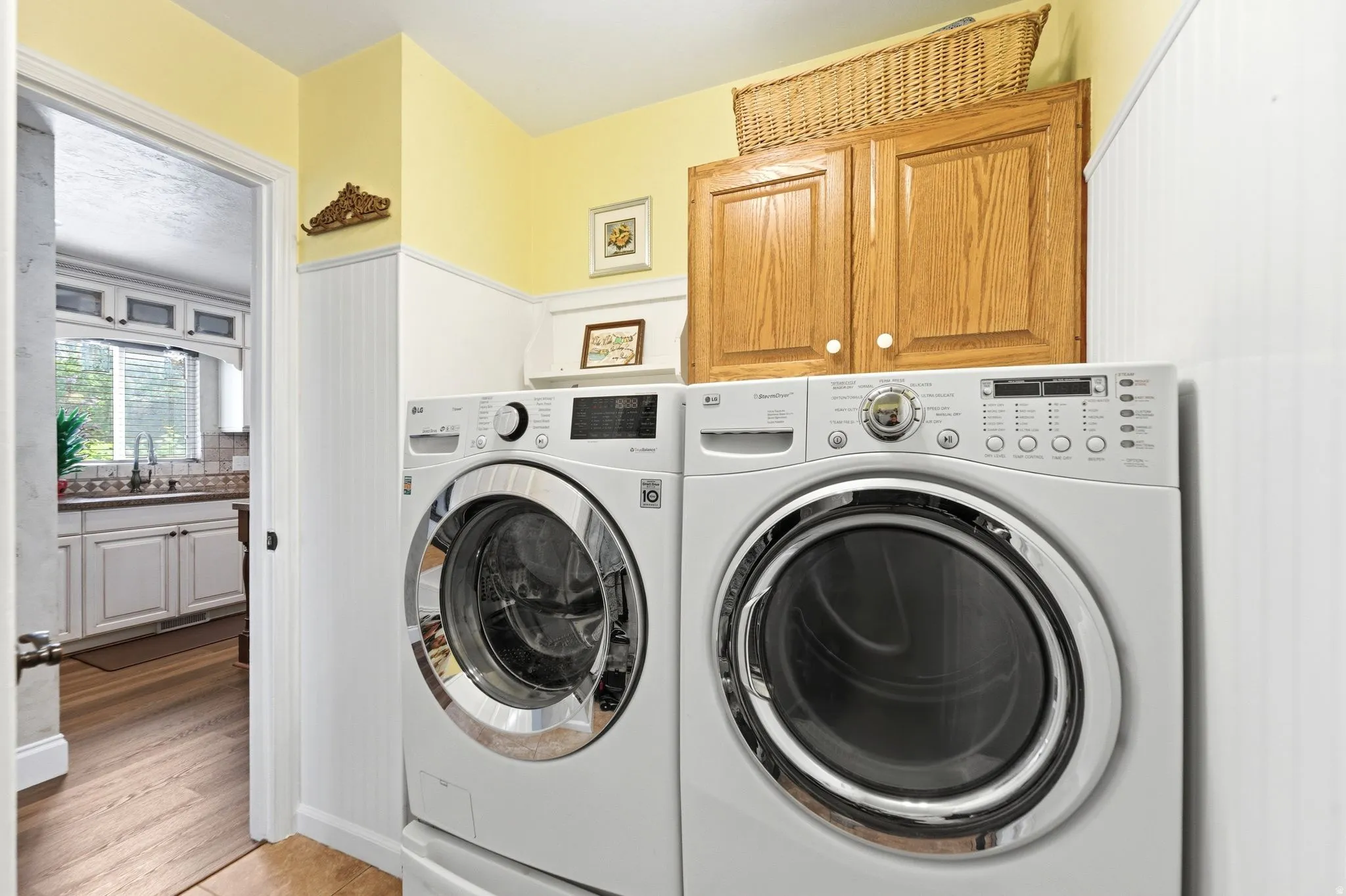 Laundry room featuring cabinet space and washer and clothes dryer