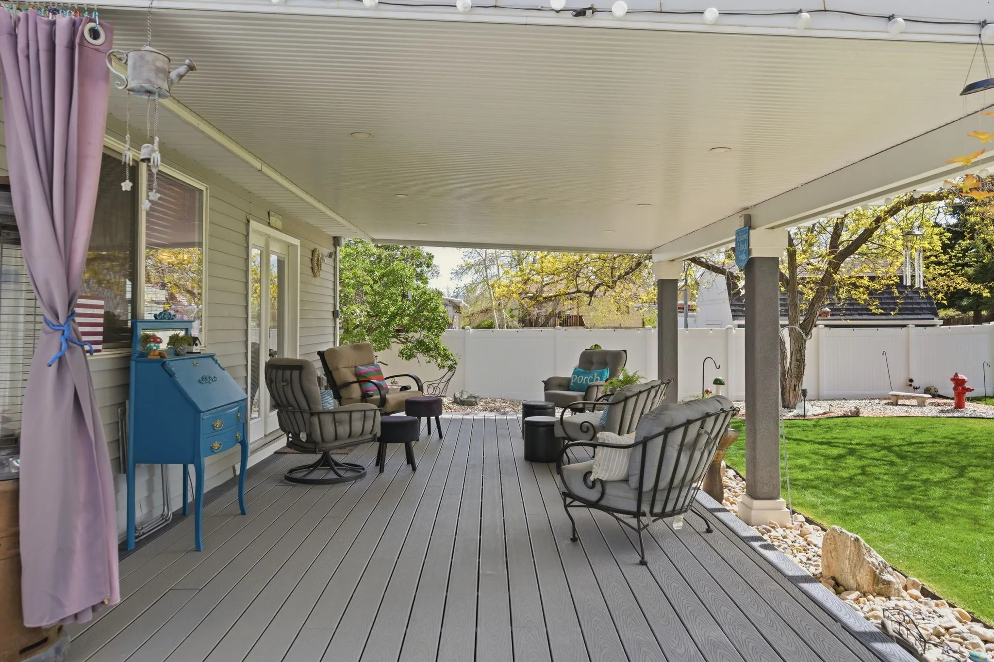 Wooden terrace with a fenced backyard, french doors, and an outdoor lounge area