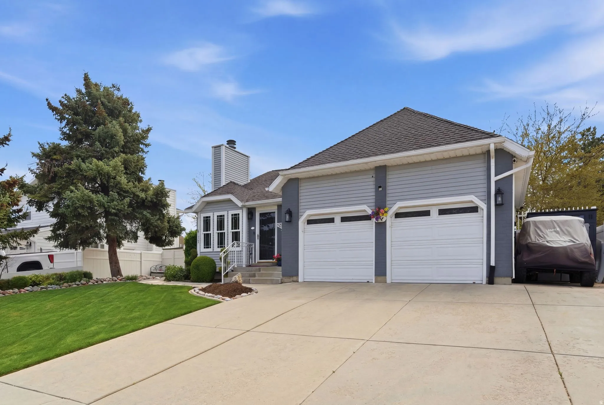 Ranch-style house with a garage, roof with shingles, concrete driveway, and a chimney