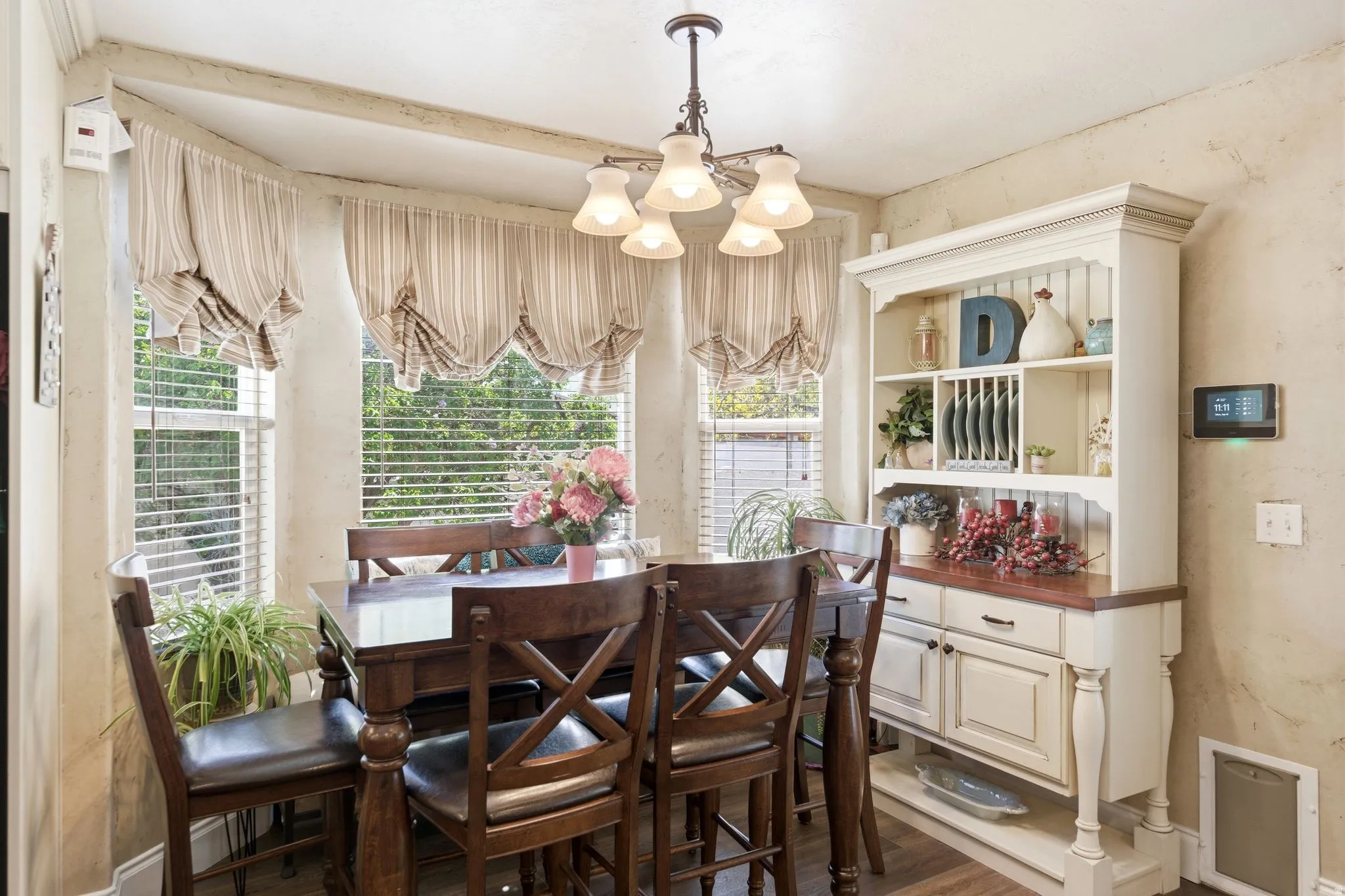 Dining area with suspended lighting and dark wood-style floors