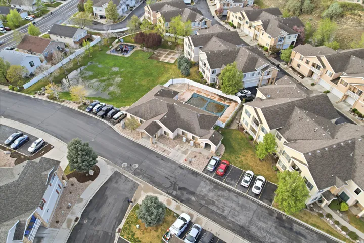 Aerial view of property and surrounding area featuring nearby suburban area