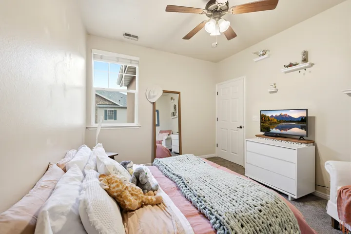 Bedroom with  walk-in closet and ceiling fan