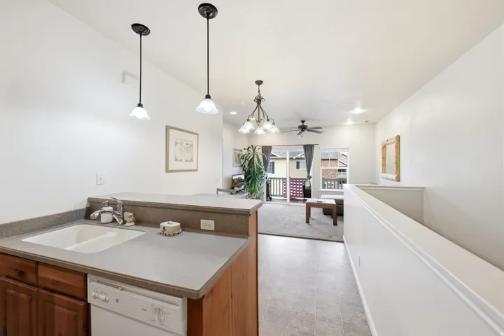 Kitchen  open floor plan into living area. pendant lighting.