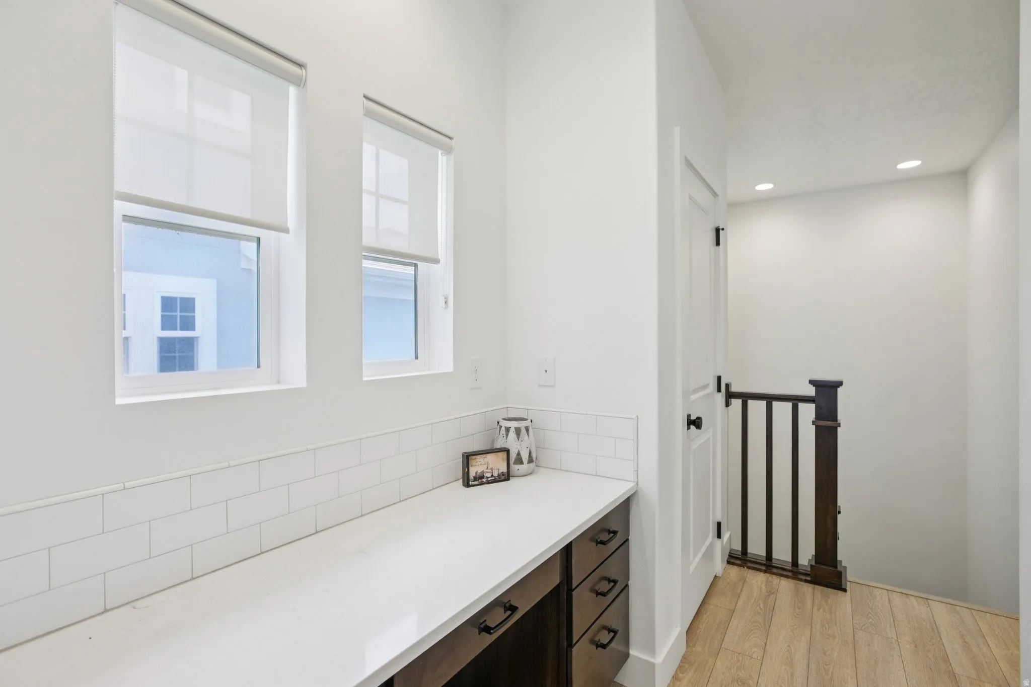 Bathroom with vanity, light wood finished floors, and recessed lighting