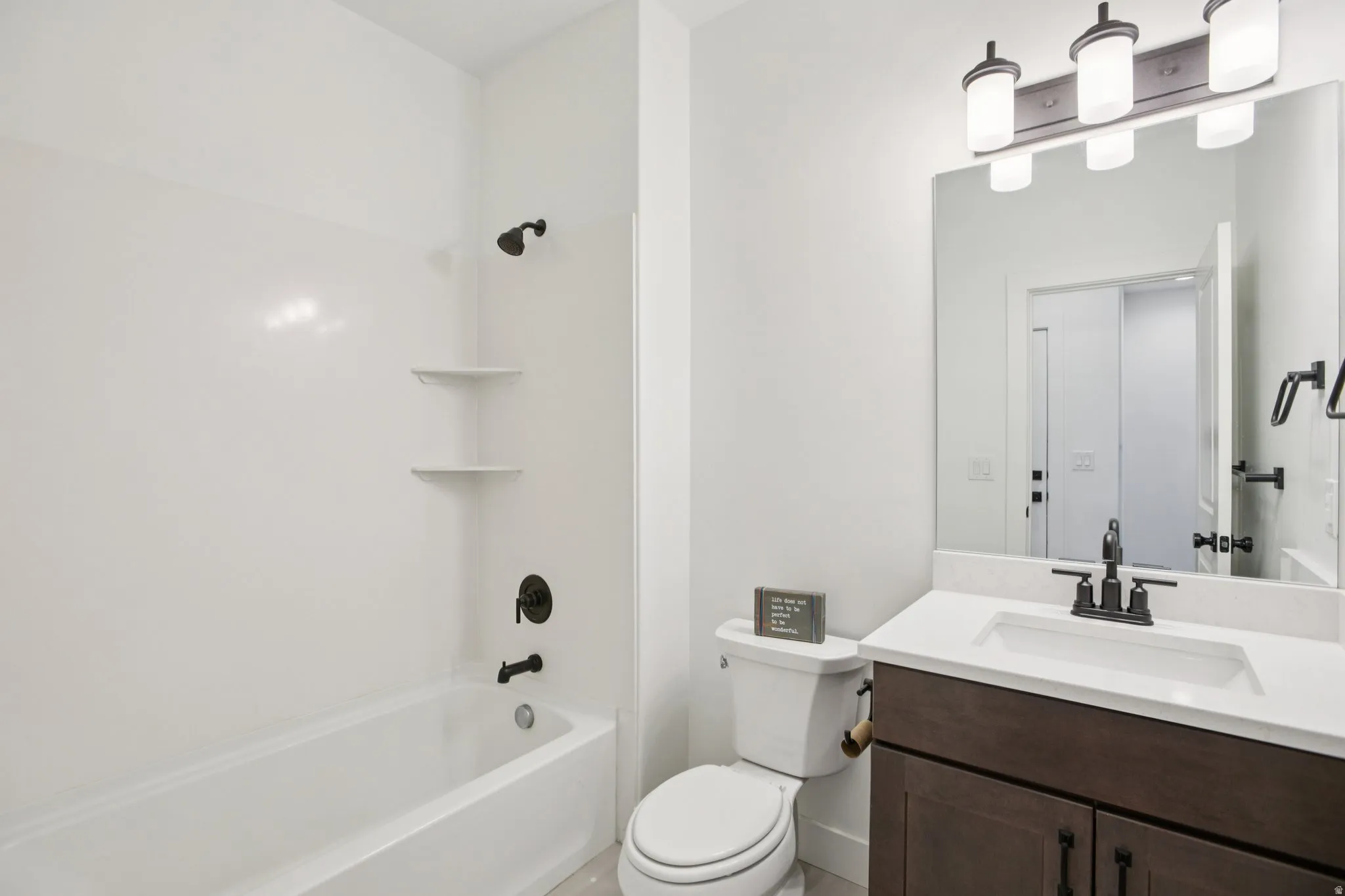 Bathroom with vanity and bathtub / shower combination