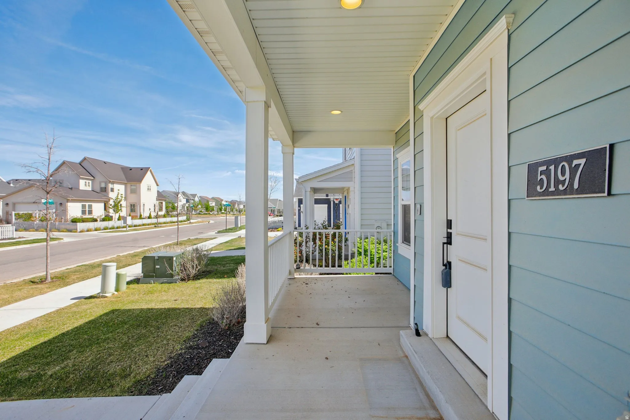 Porch featuring a residential view and a yard