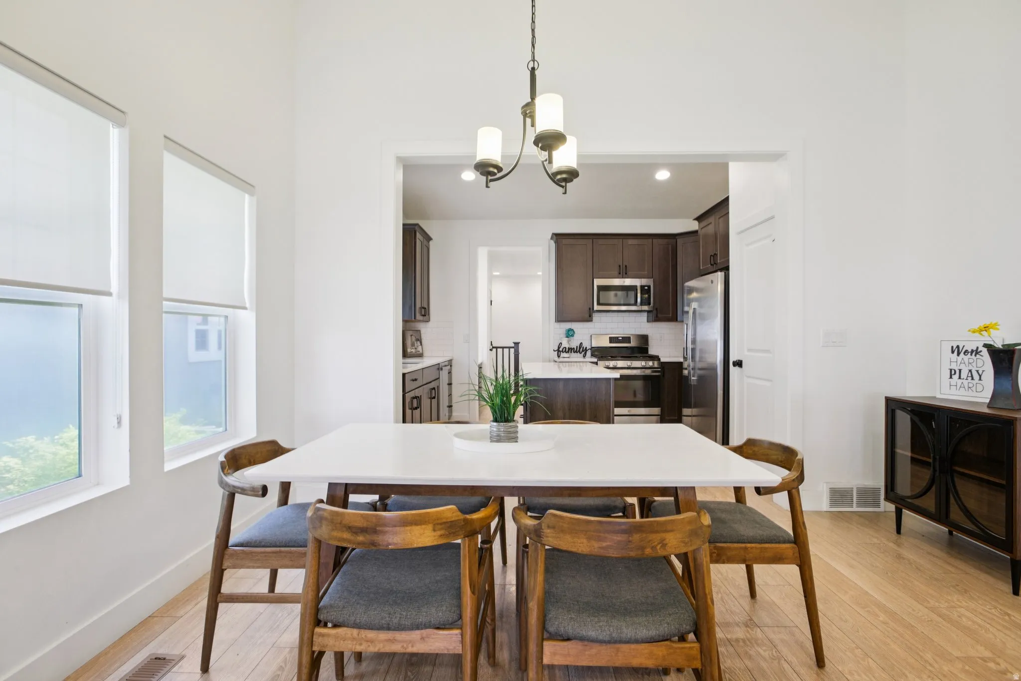 Dining space with a chandelier and light wood finished floors