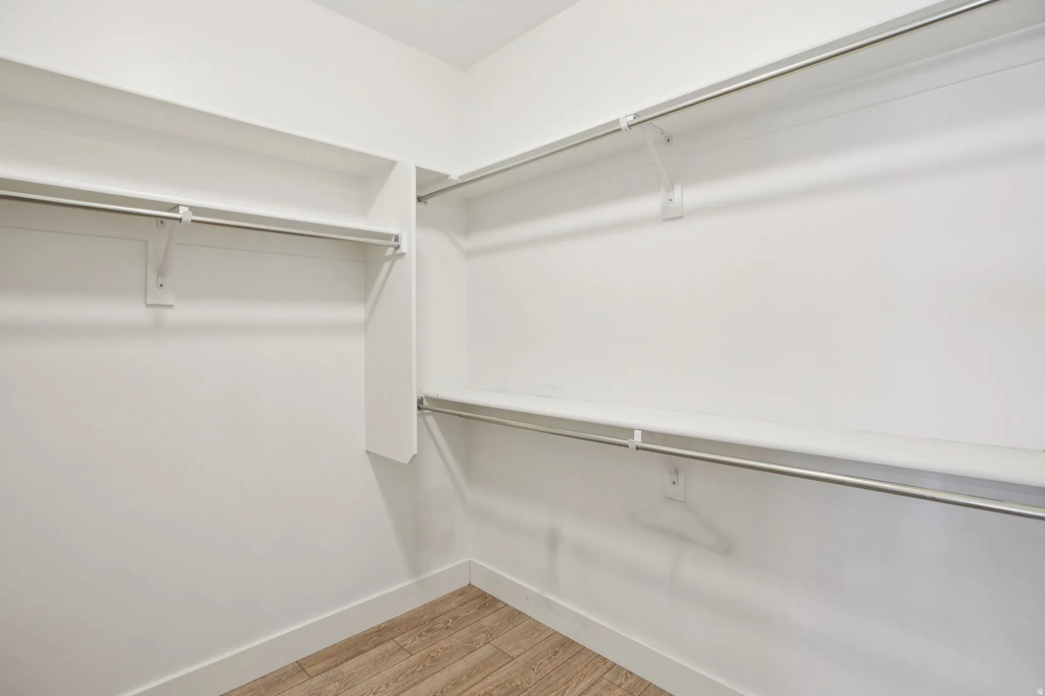 Walk in closet featuring light wood-style flooring