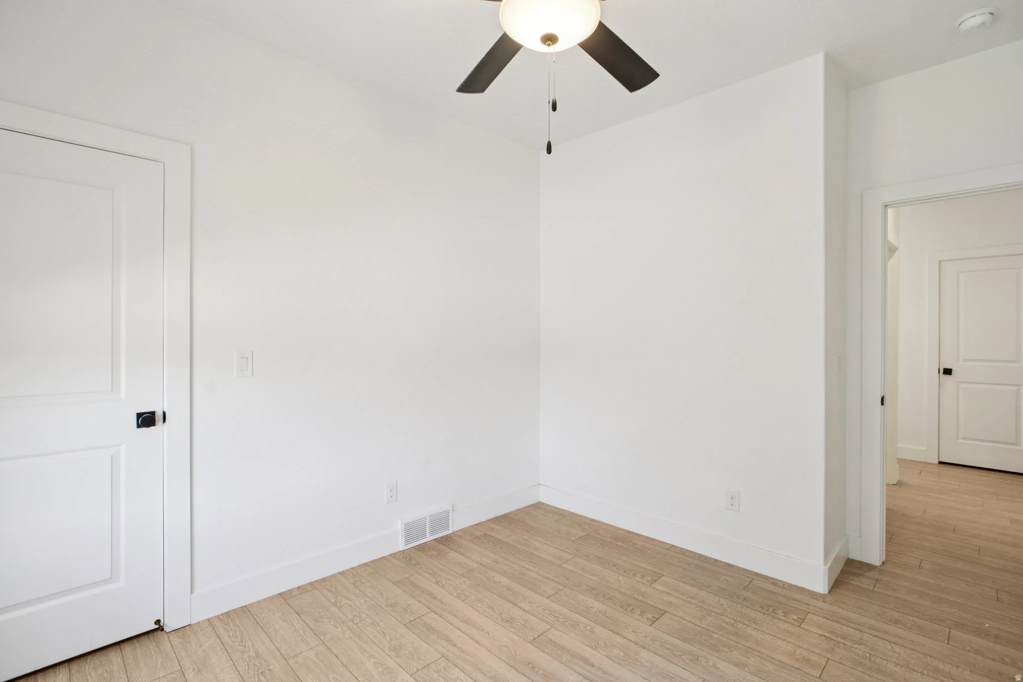 Unfurnished bedroom with light wood-style flooring and ceiling fan