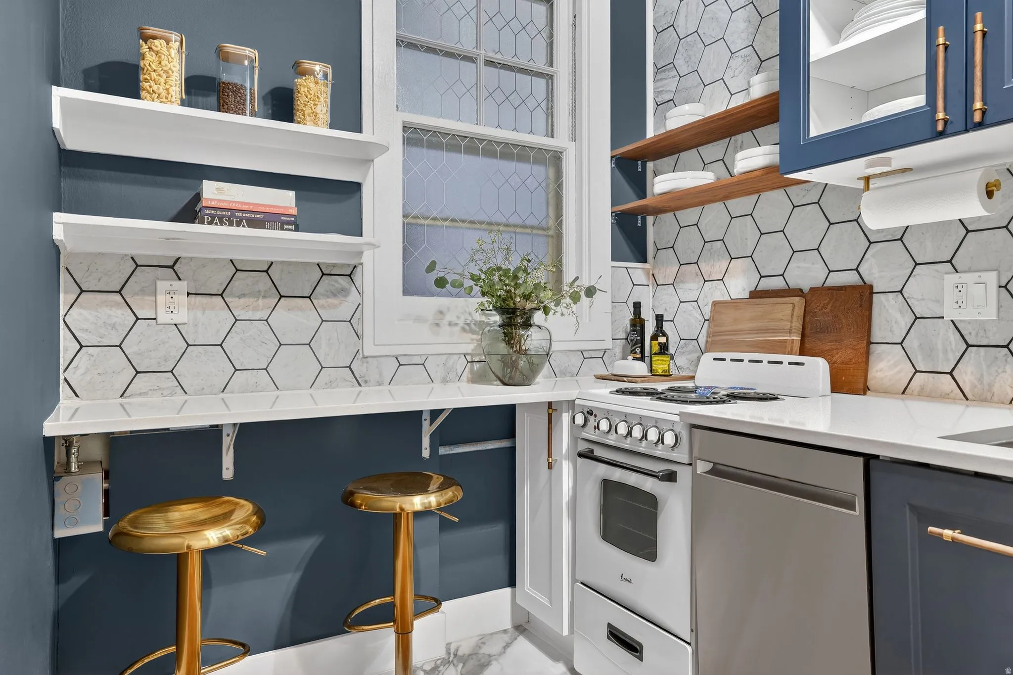 Kitchen with light stone countertops, dishwasher, tasteful backsplash, and white range oven