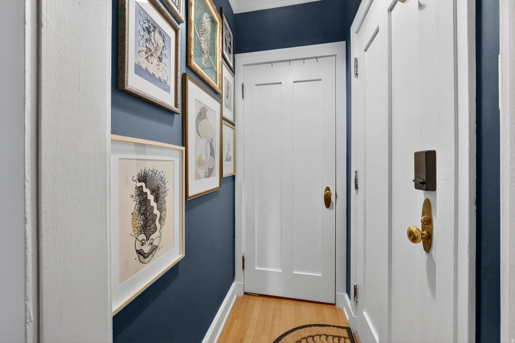 Corridor featuring light wood-style flooring and baseboards
