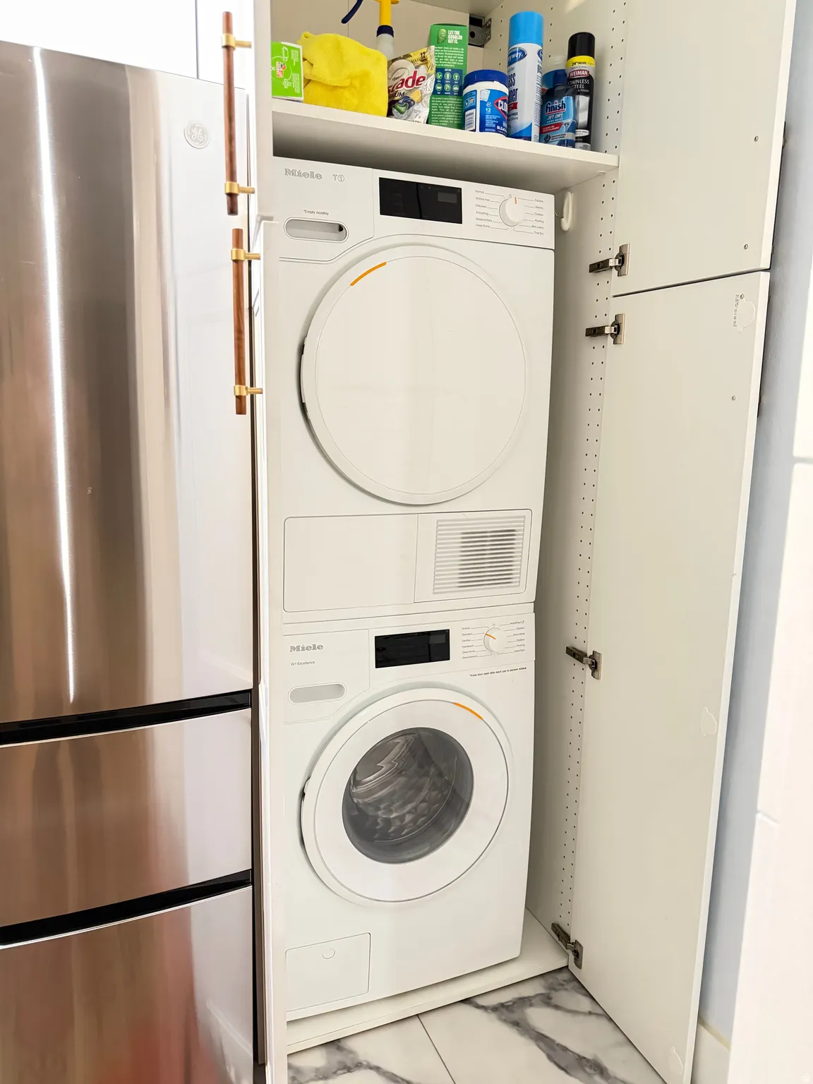 Laundry room with stacked washing machine and dryer