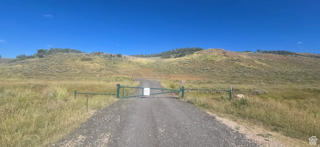 View of street featuring a mountain view, a gate, and a rural view