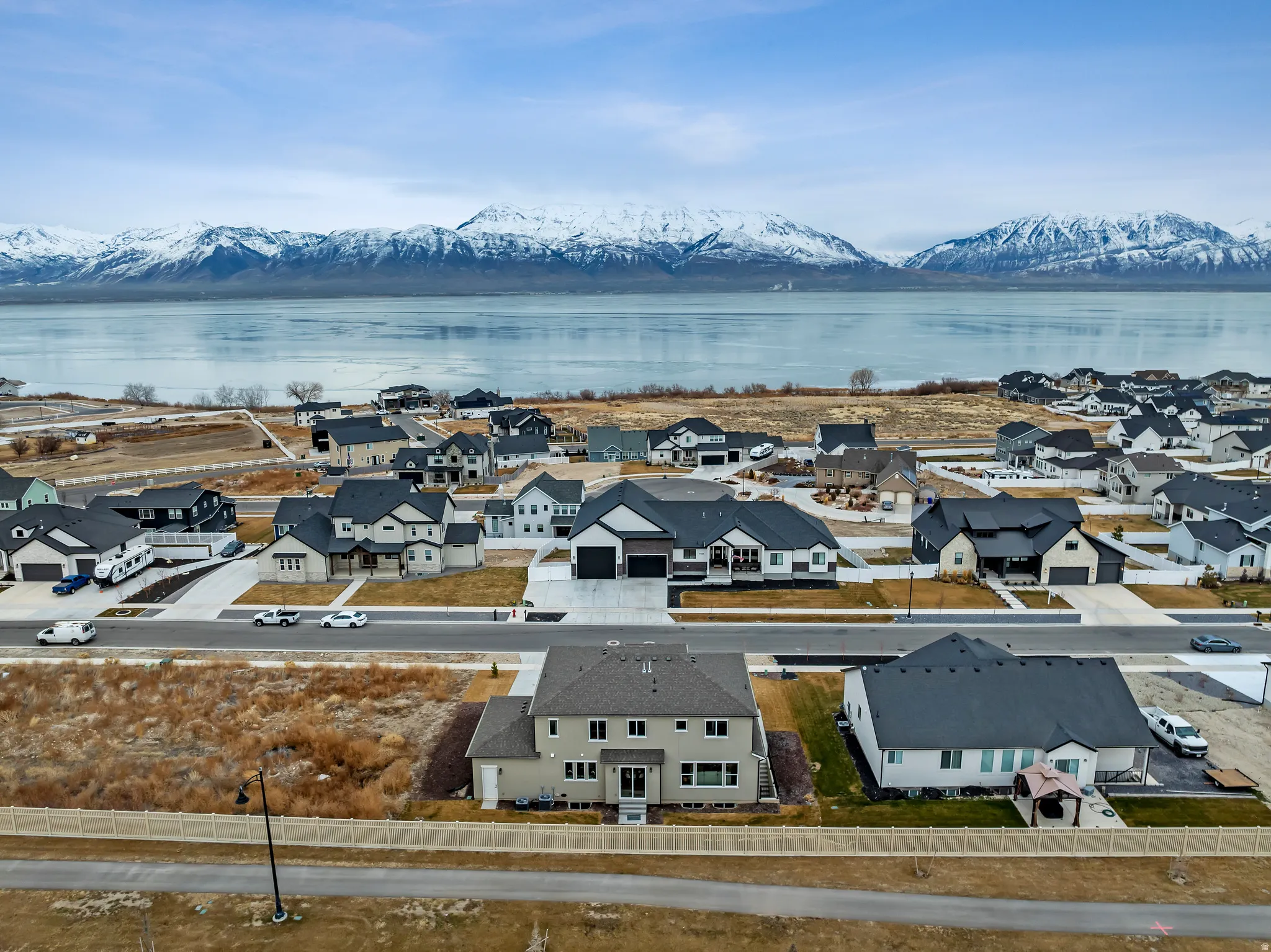 Aerial perspective of suburban area with a water and mountain view