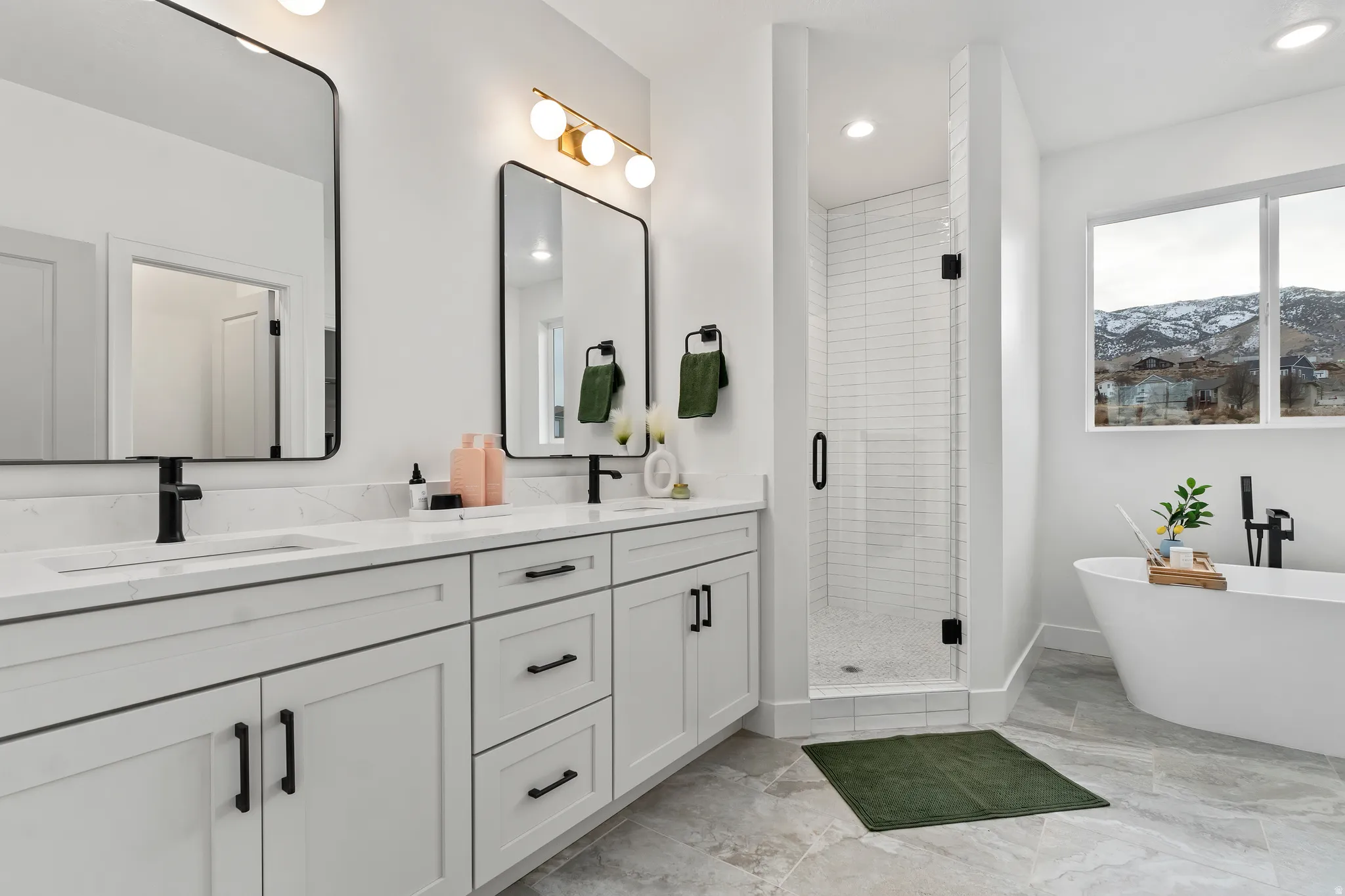Full bath with a stall shower, double vanity, recessed lighting, a freestanding tub, and a mountain view